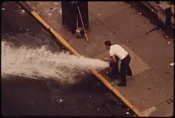 Image 32Litter is flushed from 172nd Street in Manhattan using hydrants (from History of New York City (1946–1977))