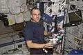 Expedition 8 mission commander and science officer Michael Foale is shown wearing a customized Lower Extremity Monitoring Suit (LEMS) and balancing on the footplate of a special track attached to the Human Research Facility (HRF) rack in the Destiny laboratory to perform a calibration for the Foot Reaction Forces During Spaceflight (Foot) experiment. - NASA Image: ISS08E06860