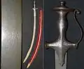 Talwar hilt with knuckle bow, 19th century, silver koftgari decoration, damascus steel blade.