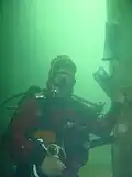 Postmaster Haakon Sandvik under water.