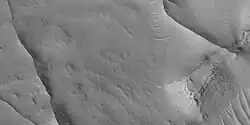 Close view of ridges, as seen by HiRISE under HiWish program This is an enlargement of a previous image. A small mesa in the image displays layers.