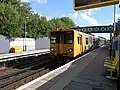 A Class 507 arrives with a service.