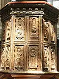 Sculpted wood panels on the pulpit
