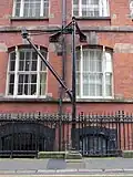 Wall crane and gate in the iron railings, to the basement warehouse below