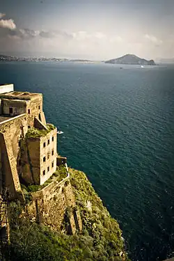 The penitentiary of Procida. The original structure, built by Cardinal Innico d'Avalos d'Aragona, was a noble palace of the d'Avalos family until it was confiscated by the Bourbons in 1734. They used it as a royal hunting residence. From 1815 it housed a military school and from 1830 it was used as a prison, undergoing various renovations.