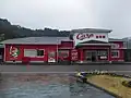The station building in 2018, in the colour scheme of the Hiroshima Toyo Carp baseball team, paid with a crowd funding project by fans.[5]