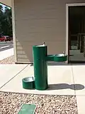 A drinking fountain with different levels for adults, youth and dogs
