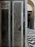 Black marble panels with finely carved calligraphic compositions, a feature not found in earlier Mamluk architecture