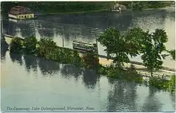 A postcard of a streetcar crossing a long causeway