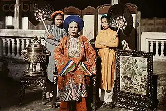 Princess Mỹ Lương, eldest daughter of emperor Dục Đức seated in front of Bình phong