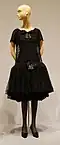 Sheer lace canopies a form fitting layer by lowering and expanding waistline