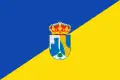 A two color flag, divided equally in two, with the top left side blue and de bottom right yellow. The coat of arms is on the middle.