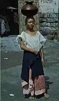 Filipina woman wearing baro't saya while working.
