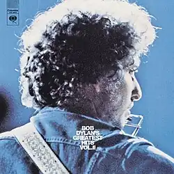 A photograph of the back of Dylan's head as he turns toward the camera