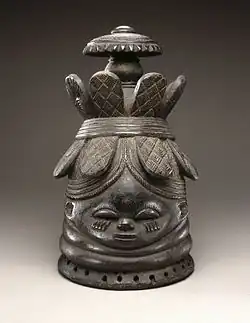 Helmet mask (ndoli jowei) for Sande society; late 19th-early 20th century; wood; 39.4 x 23.5 x 26&nbsp;cm (151⁄2 x 91⁄4 x 101⁄4 in.); Brooklyn Museum (New York City). A vertical crack runs from base of mask to head band at back center and includes a triangular 13⁄4 hole below band