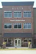 Contemporary campus building in Mechanicville, NY, north of Albany with modern Bryant & Stratton College sign.