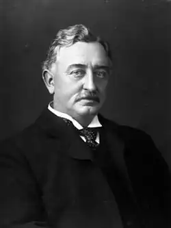 Man in a suit facing forward towards camera.