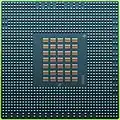 The underside of the 90&nbsp;nm Cell/B.E. processor showing its 1242 solder balls, each 0.6&nbsp;mm in diameter, and its array of 35 capacitors