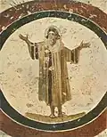 Man praying in orans position