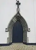 Main entrance of the Church of the Holy Rosary in Doolin. Note the stonework around the door, showing that the church is way older than its modern looks