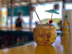 Coconut with straw at restaurant in Esperanza, Vieques