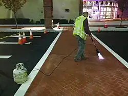 Image 12Polymer cement overlaying to change asphalt pavement to brick texture and color to create decorative crosswalk (from Road surface)