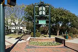 A clock in a small public square with a sign proclaiming it the hometown of Kellie Pickler