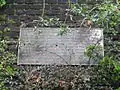 Plaque on the retaining wall commemorating the station