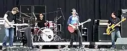 Four men performing onstage