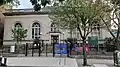 Eastern Parkway Library, a tall single-story building made of light stone