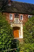 Monoux Almshouses in the village