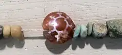Characteristic Indian etched carnelian bead, found in Ptolemaic Period excavations at Saft el-Hinna, Ptolemaic Egypt. Petrie Museum.