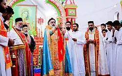 Picture of the clergy wearing their different vestments