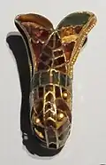 A fibula in the shape of an insect (GNM)