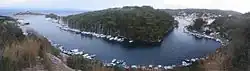 Panoramic view of the strait surrounding St Nicolas islet (center): the islet and monastery of Panagia to the north (left), port and main settlement of Gaios to the center and south (right).