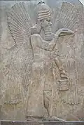 Relief with a winged genie with bucket and cone; 713–706 BC; height: 3.3 m; Louvre