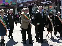 A group of smiling people marching