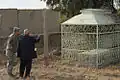A U.S. soldier and the shrine's caretaker