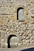 the original elevated entrance and the 17th-century ground level door