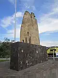 Stone sculpture of an eagle and flagpole