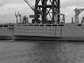 A Mexeflote suspended from the starboard flank of HMAS&nbsp;Choules