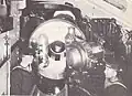 The starboard 12-inch (305&nbsp;mm) Mark VIII gun in one of the turrets aboard the battleship HMS Illustrious. The gun's breech is open.