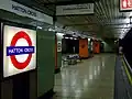 Platform with backlit roundel and speedbird mosaics on central columns