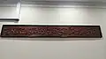 Arabic calligraphy of the Ayat al-Kursi mounted on a wall.