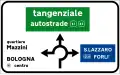 Directions at a roundabout in urban areas. The green panel indicates a motorway
