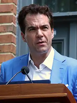 Jack Burman standing at a podium