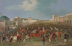 mid-nineteenth-century colour painting of race-course, racehorses and race-goers with buildings either side of the course under a partly-cloudy sky