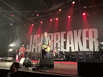 People on a stage performing with instruments