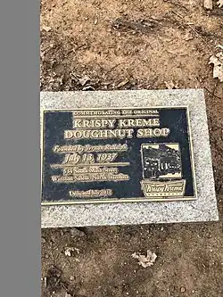 Commemorating the original Krispy Kreme doughnut shop. Founded by Vernon Rudolph, July 13, 1937. 534 South Main Street, Winston-Salem, North Carolina. Dedicated July 2012.