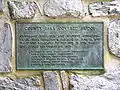 A metal nameplate describing history of the bridge